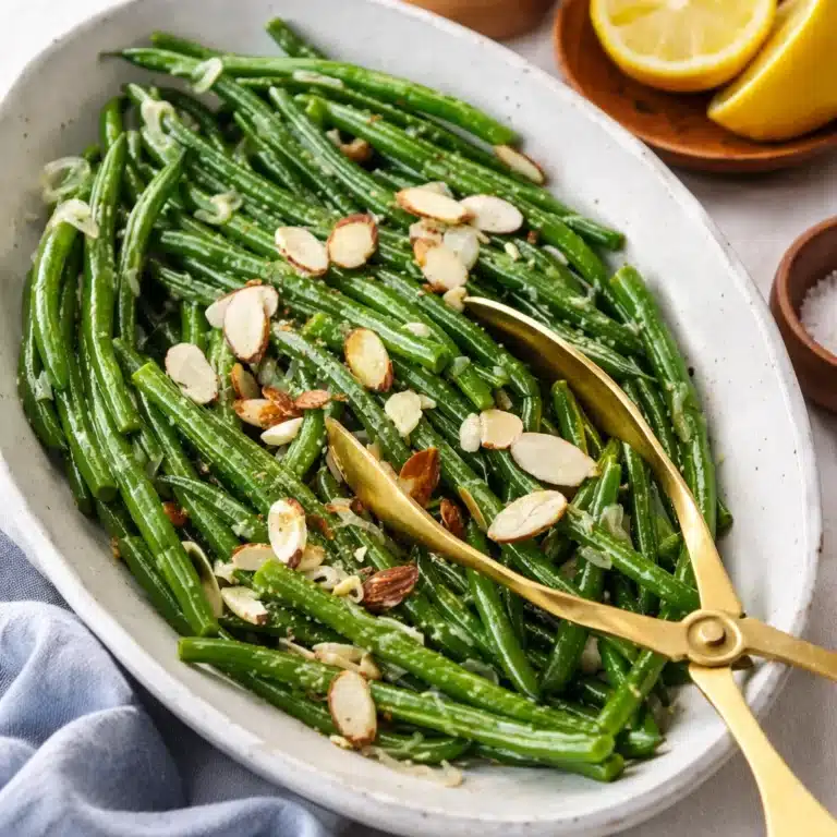 A plate of Green Beans Almondine with garlic, toasted almonds, and lemon zest.
