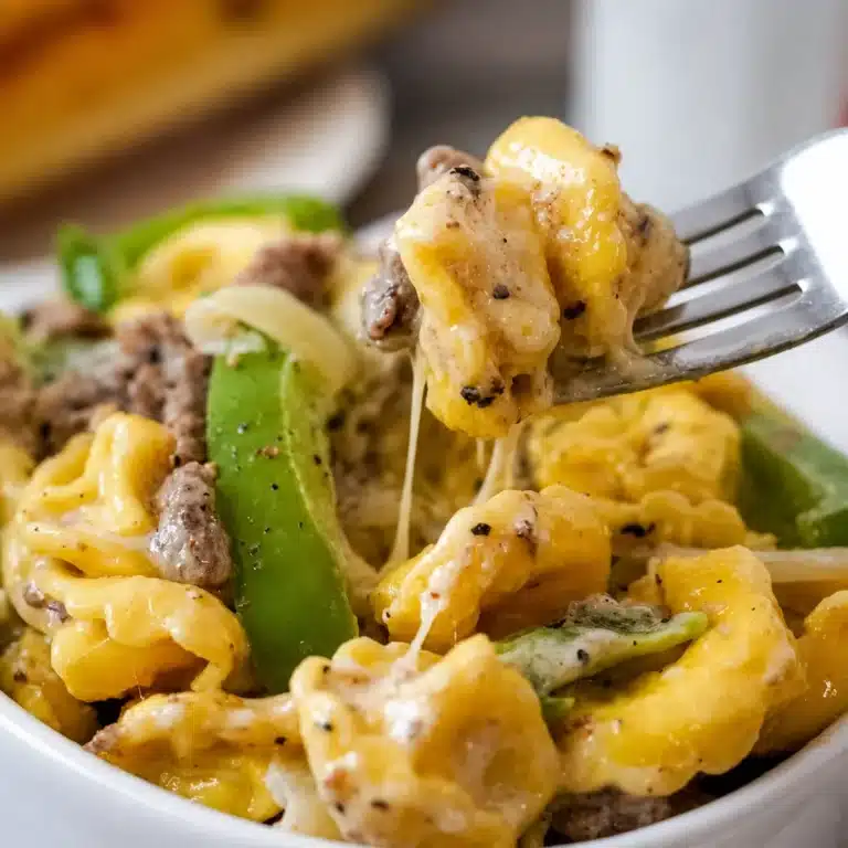 Creamy Crock Pot Cheesesteak Tortellini with beef, peppers, and cheese